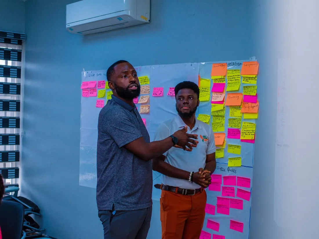 A Bragi facilitator mapping ideas across a wall of sticky notes during a co-design session.